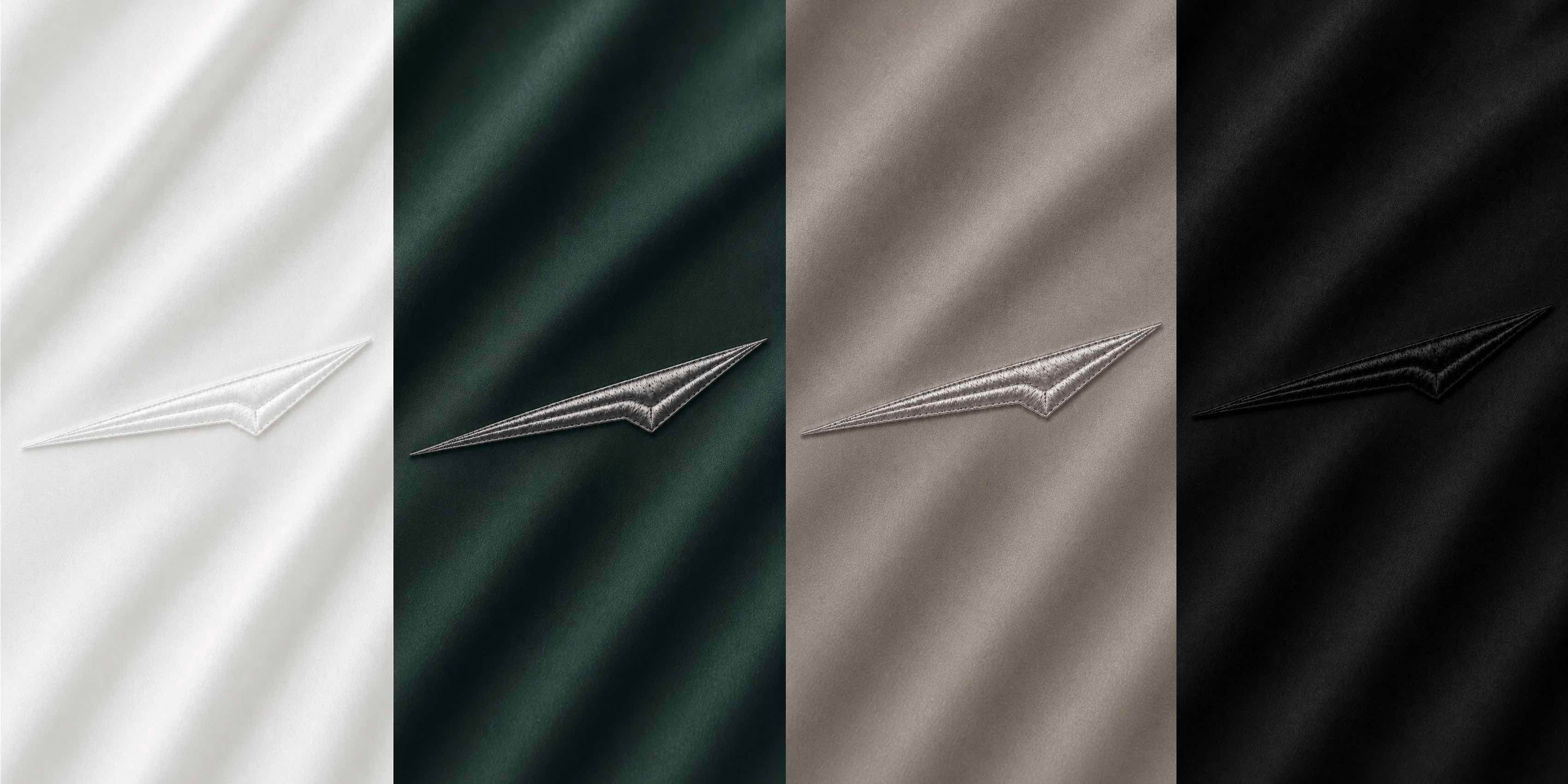 Edition One — four colourways: Ivory, Forest, Taupe, Obsidian. Chrome mark embroidered in matched thread.